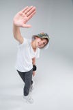A guy is a teenager, stands in a dancing pose, lifting one hand with his hand. Forward. View from above. royalty free stock images A guy is a teenager, stands in a dancing pose, lifting one hand with his hand. Forward. View from above. royalty free stock images