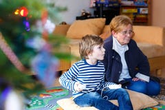 Little kid boy and grandmother playing video game console Stock Photo Little kid boy and grandmother playing video game console Stock Photo
