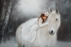 The little princess with an unicorn in the forest.