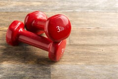 Little red dumbbells on the floor stock image Little red dumbbells on the floor stock image
