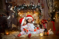 Little sisters in pajamas at Christmas Eve Stock Image Little sisters in pajamas at Christmas Eve Stock Image