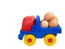 Little toy truck full of fresh organic eggs