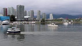 Little water taxi, City downtown harbor yachts, boats and sails. Silent water, mountains and cloudy sky