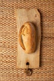 A loaf of bread on weave grass background showing texture. Royalty Free Stock Photography A loaf of bread on weave grass background showing texture. Royalty Free Stock Photography