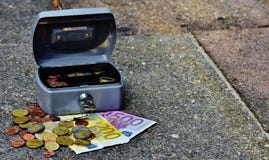 Lock box with bills and coins Lock box with bills and coins