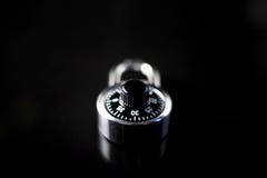 Locked padlock on a black background with reflection on glass royalty free stock photos Locked padlock on a black background with reflection on glass royalty free stock photos