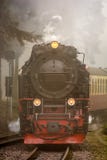 Steam locomotive with trailers drives through the fog stock images Steam locomotive with trailers drives through the fog stock images