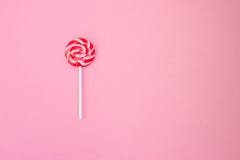 lollipop Ριγωτό lollipop σε ένα ήπια ρόδινο υπόβαθρο Κόκκινα και άσπρα λωρίδες στην καραμέλα στοκ φωτογραφίες lollipop Ριγωτό lollipop σε ένα ήπια ρόδινο υπόβαθρο Κόκκινα και άσπρα λωρίδες στην καραμέλα στοκ φωτογραφίες