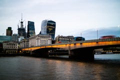 London Bridge with busses travelling across it in the evening stock photos London Bridge with busses travelling across it in the evening stock photos