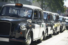 London Taxis Lined Up On Sidewalk Stock Photo London Taxis Lined Up On Sidewalk Stock Photo