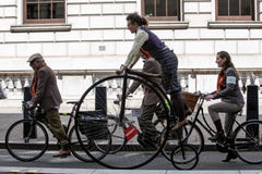 Metropolitan bicycle ride. People with old bicycles and clothes stock photography Metropolitan bicycle ride. People with old bicycles and clothes stock photography