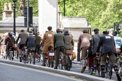 Metropolitan bicycle ride. People with old bicycles and clothes royalty free stock photography Metropolitan bicycle ride. People with old bicycles and clothes royalty free stock photography