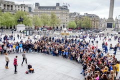 Tourists enjoy the performance show in Trafalgar Square in London, UK. royalty free stock photography Tourists enjoy the performance show in Trafalgar Square in London, UK. royalty free stock photography