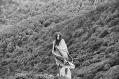 Loneliness on the edge of the cliff. Pretty girl on green mountains Royalty Free Stock Photography Loneliness on the edge of the cliff. Pretty girl on green mountains Royalty Free Stock Photography