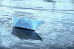 Lonely blue paper boat in shallow water royalty free stock photos Lonely blue paper boat in shallow water royalty free stock photos