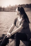 Lonely pregnant girl sits on the lake and looks into the distance stock images Lonely pregnant girl sits on the lake and looks into the distance stock images