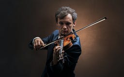 Violinst playing on instrument with empathy stock photo Violinst playing on instrument with empathy stock photo
