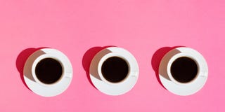 Long banner for cafes bars. White Cups of Coffee with Saucer on Neon Fuchsia Pink Color Background. Top View royalty free stock images Long banner for cafes bars. White Cups of Coffee with Saucer on Neon Fuchsia Pink Color Background. Top View royalty free stock images