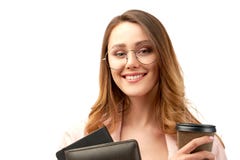 Long-haired cute smiling brunette business lady holding a folder with documents and a Cup of coffee or tea. stock photography Long-haired cute smiling brunette business lady holding a folder with documents and a Cup of coffee or tea. stock photography