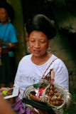 The long-haired woman of the Yao people sells souvenirs to tourists. stock photography The long-haired woman of the Yao people sells souvenirs to tourists. stock photography