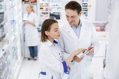 Pleasant two pharmacists checking presence stock image Pleasant two pharmacists checking presence stock image