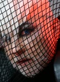 Looking freaky. BDSM fashion accessory. Heterosexual man with male makeup. Transgender man cover face with fishnet. Male stock images Looking freaky. BDSM fashion accessory. Heterosexual man with male makeup. Transgender man cover face with fishnet. Male stock images