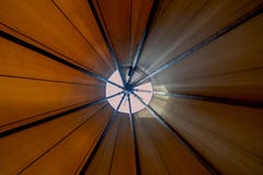 Looking up towards teepee-ceiling from inside the tent shows bright day light filtering in creating a cozy ambience royalty free stock image Looking up towards teepee-ceiling from inside the tent shows bright day light filtering in creating a cozy ambience royalty free stock image
