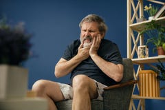 Old bearded man suffering from pain stock images Old bearded man suffering from pain stock images