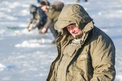 Los hombres se sientan en el hielo y los pescados Pesca del invierno en Rusia fotos de archivo libres de regalías Los hombres se sientan en el hielo y los pescados Pesca del invierno en Rusia fotos de archivo libres de regalías