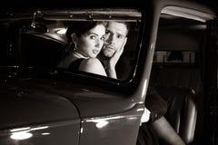 Los pares atractivos apuestos, hombre hermoso en traje, mujer hermosa en vestido rojo, son abarcamiento descubierto en coche del fotos de archivo Los pares atractivos apuestos, hombre hermoso en traje, mujer hermosa en vestido rojo, son abarcamiento descubierto en coche del fotos de archivo