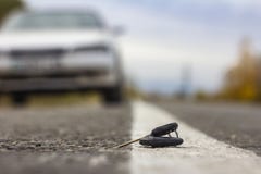 Lost car keys lying on the roadway, on a blurred background with bokeh effect stock photography Lost car keys lying on the roadway, on a blurred background with bokeh effect stock photography