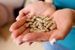 Capsules with medicine in the hands of a girl stock image Capsules with medicine in the hands of a girl stock image