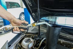 A lot of Engine oil is filled into a car engine stock images A lot of Engine oil is filled into a car engine stock images
