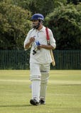 Man walking out to bat at local charity cricket match stock images Man walking out to bat at local charity cricket match stock images