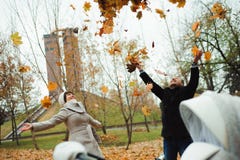 Love, relationships, season and people concept - happy young couple throwing autumn leaves up in park. stock photography Love, relationships, season and people concept - happy young couple throwing autumn leaves up in park. stock photography