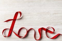 Love Ribbon Twisted Word, Wooden Background. Valentine Day Concept stock photo Love Ribbon Twisted Word, Wooden Background. Valentine Day Concept stock photo