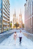 Amazing Love story of the beautiful young loving brunette man and woman, embrace on a city walk, walking at sunset under stock images Amazing Love story of the beautiful young loving brunette man and woman, embrace on a city walk, walking at sunset under stock images