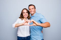 Love story of cheerful, attractive, mature, adult, lovely, cute, sweet couple in casual outfit, jeans, shirt making heart with royalty free stock photos Love story of cheerful, attractive, mature, adult, lovely, cute, sweet couple in casual outfit, jeans, shirt making heart with royalty free stock photos