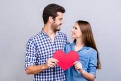 Love story. Trust and feelings, emotions and joy. Happy young lovely couple in love is posing, wearing casual shirts, holding big