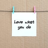 Love what you do. Note is written on a white sticker that hangs Royalty Free Stock Photography Love what you do. Note is written on a white sticker that hangs Royalty Free Stock Photography
