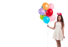 Lovely girl brunette with long hair in a white dress with a bow on her head and balloons posing on a white background Stock Photo Lovely girl brunette with long hair in a white dress with a bow on her head and balloons posing on a white background Stock Photo