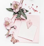Lovely Pastel Pink Layout With Flowers Decoration, Ribbon, Hearts And Card Mock Up On White Desk Background, Top View, Flat Lay. W Royalty Free Stock Image