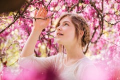 Lovely tender young woman in spring garden with blooming trees stock image Lovely tender young woman in spring garden with blooming trees stock image
