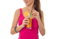 Lovely young girl in pink shirt drink orange cocktail and smiling isolated on white background stock images Lovely young girl in pink shirt drink orange cocktail and smiling isolated on white background stock images