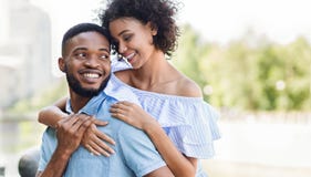 Loving african-american couple in love hugging in park stock image Loving african-american couple in love hugging in park stock image