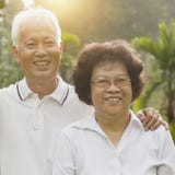Loving Asian seniors couple outdoors royalty free stock photography Loving Asian seniors couple outdoors royalty free stock photography