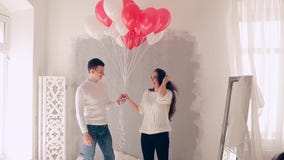 Loving couple on the bed with balloons stock video footage Loving couple on the bed with balloons stock video footage