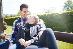 Loving couple relaxing on a park bench royalty free stock photography Loving couple relaxing on a park bench royalty free stock photography