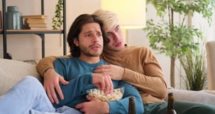 loving-gay-couple-eating-popcorn-watching-tv-sitting-sofa-home-gay-couple-eating-popcorn-watching-tv-home-203890210.jpg