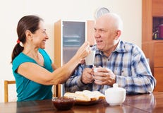 Loving mature couple having tea with jam Royalty Free Stock Photo Loving mature couple having tea with jam Royalty Free Stock Photo
